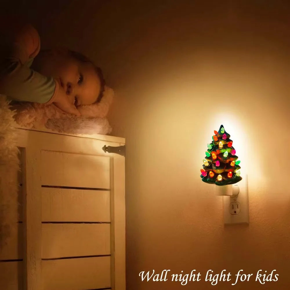 Child lying on a bed next to a wall night light shaped like a Christmas tree, with text 'Wall night light for kids'.